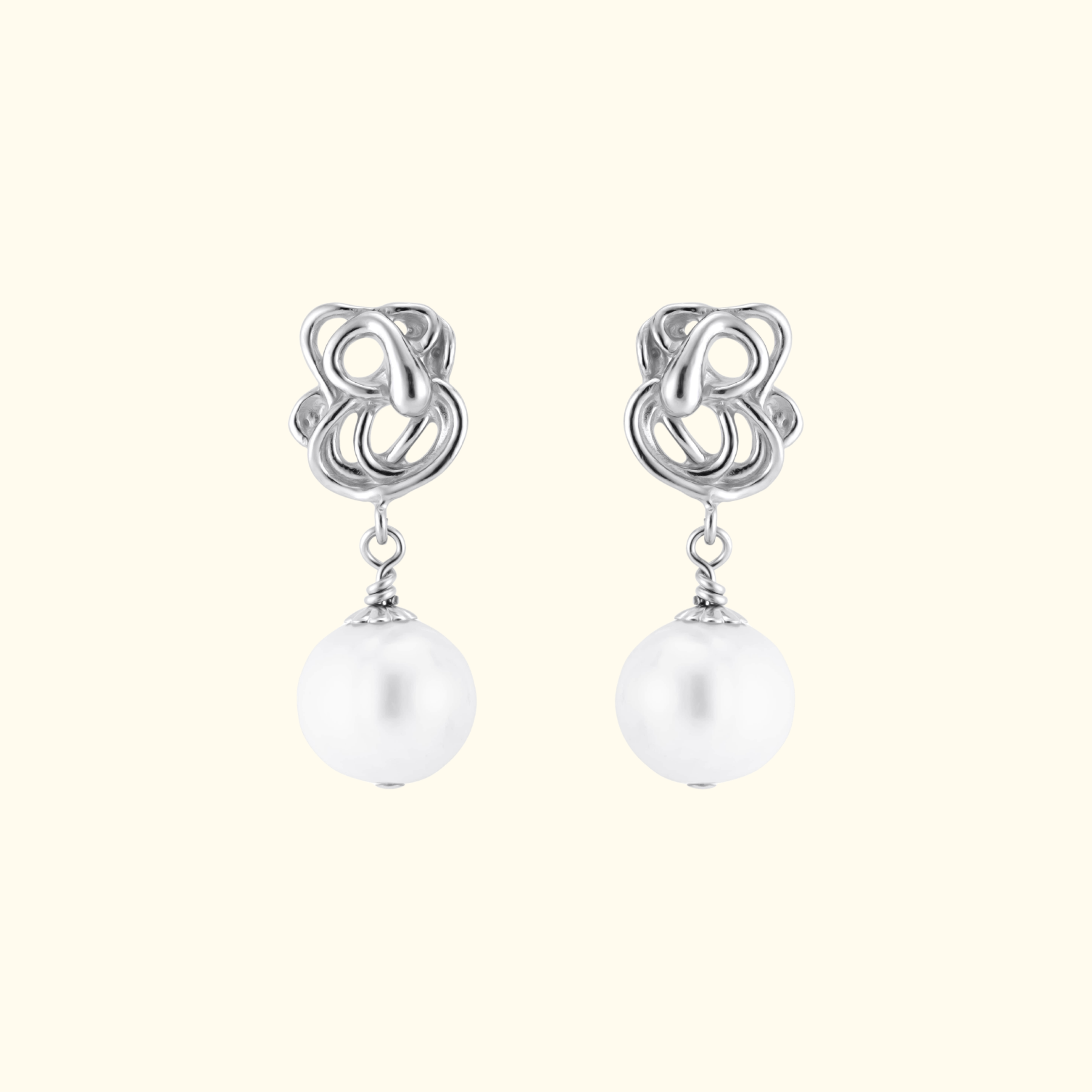front view of abstract sterling silver pearl drop earrings by jessica liu
