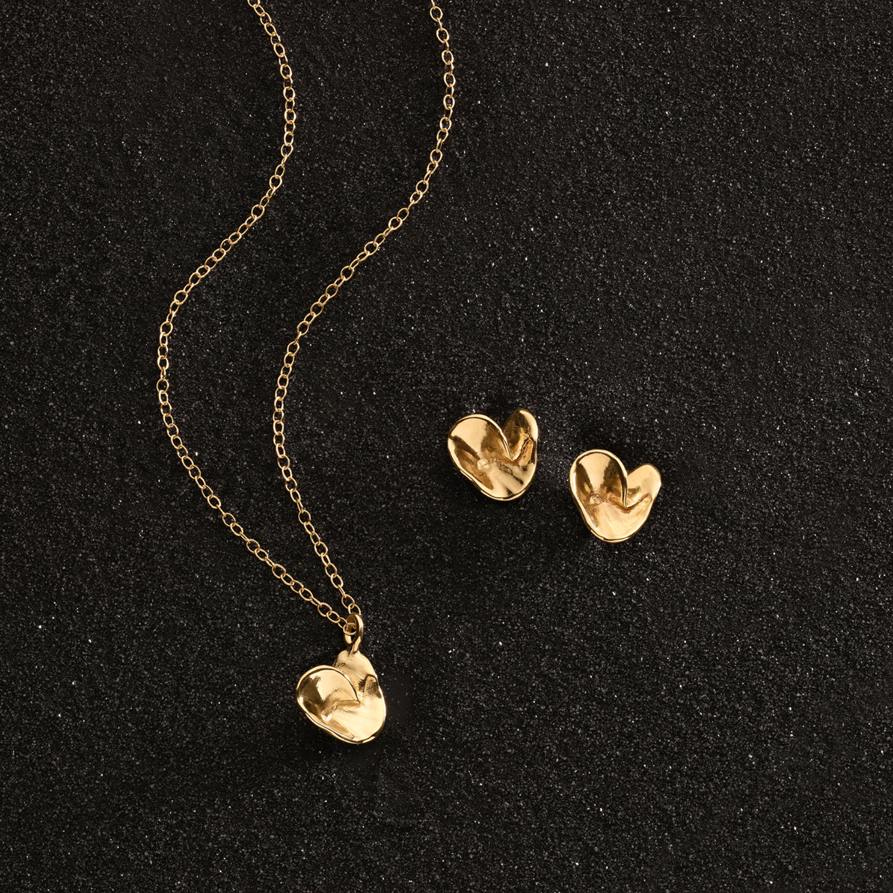 folded origami heart necklace in 14k gold with matching heart earrings by jessica liu