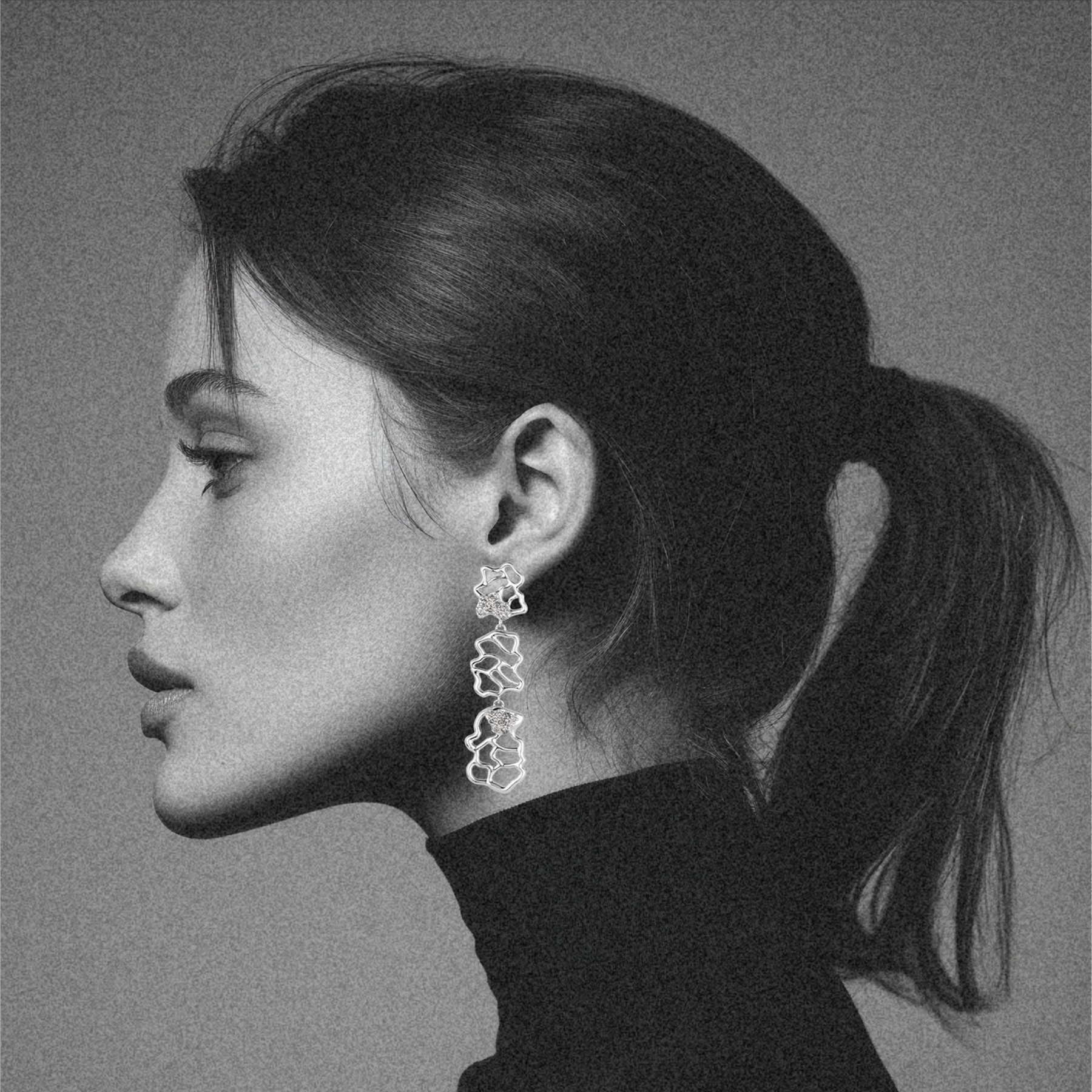 woman wearing organic abstract three drop earrings in white gold with salt and pepper diamonds by jessica liu