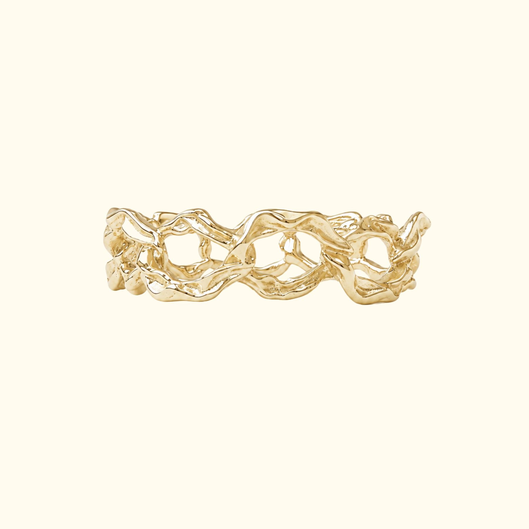 A gold chain link ring by Jessica Liu with an organic, wavy, textured design, shown on a plain cream-colored background.