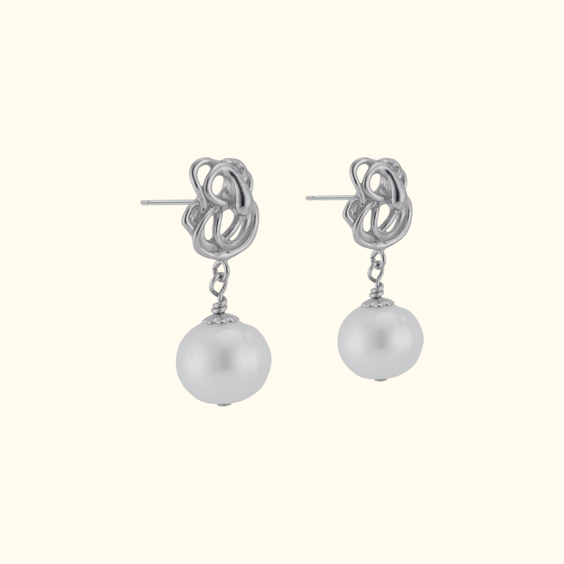 side view of abstract sterling silver pearl drop earrings by jessica liu