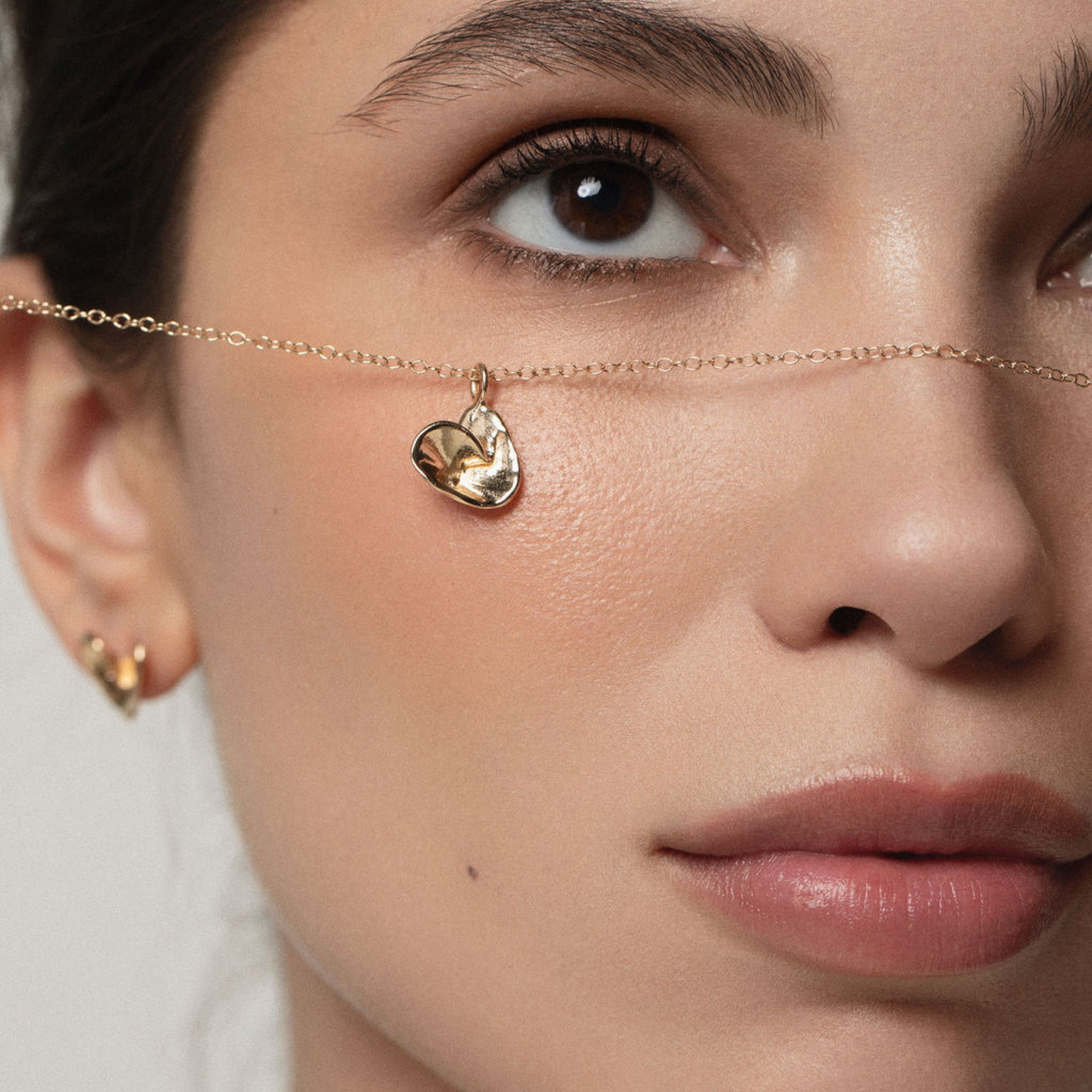 folded origami heart necklace in 14k gold modeled 1 by jessica liu