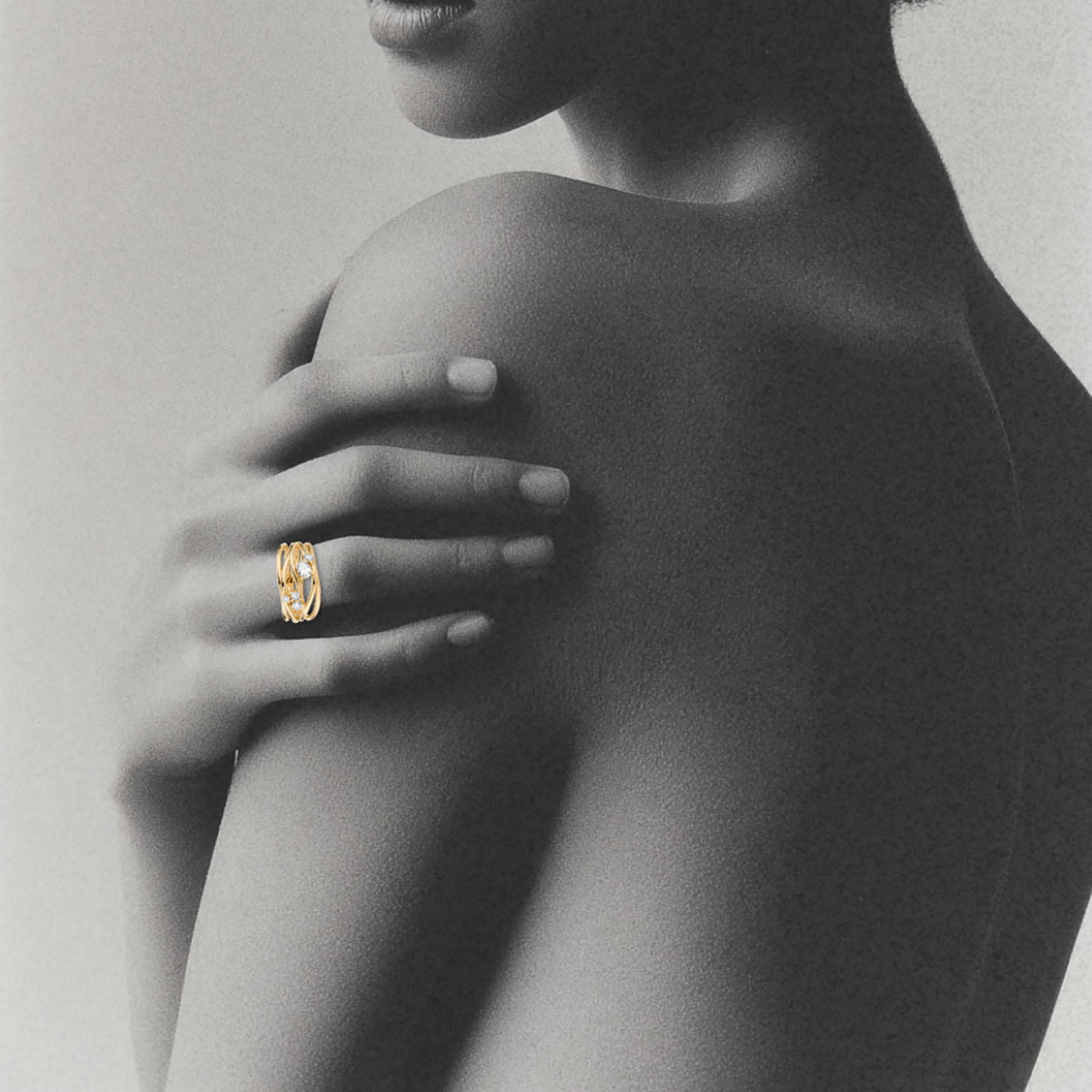 woman's hand wearing organic interweaving 14k gold ring with 5 white diamonds by jessica liu