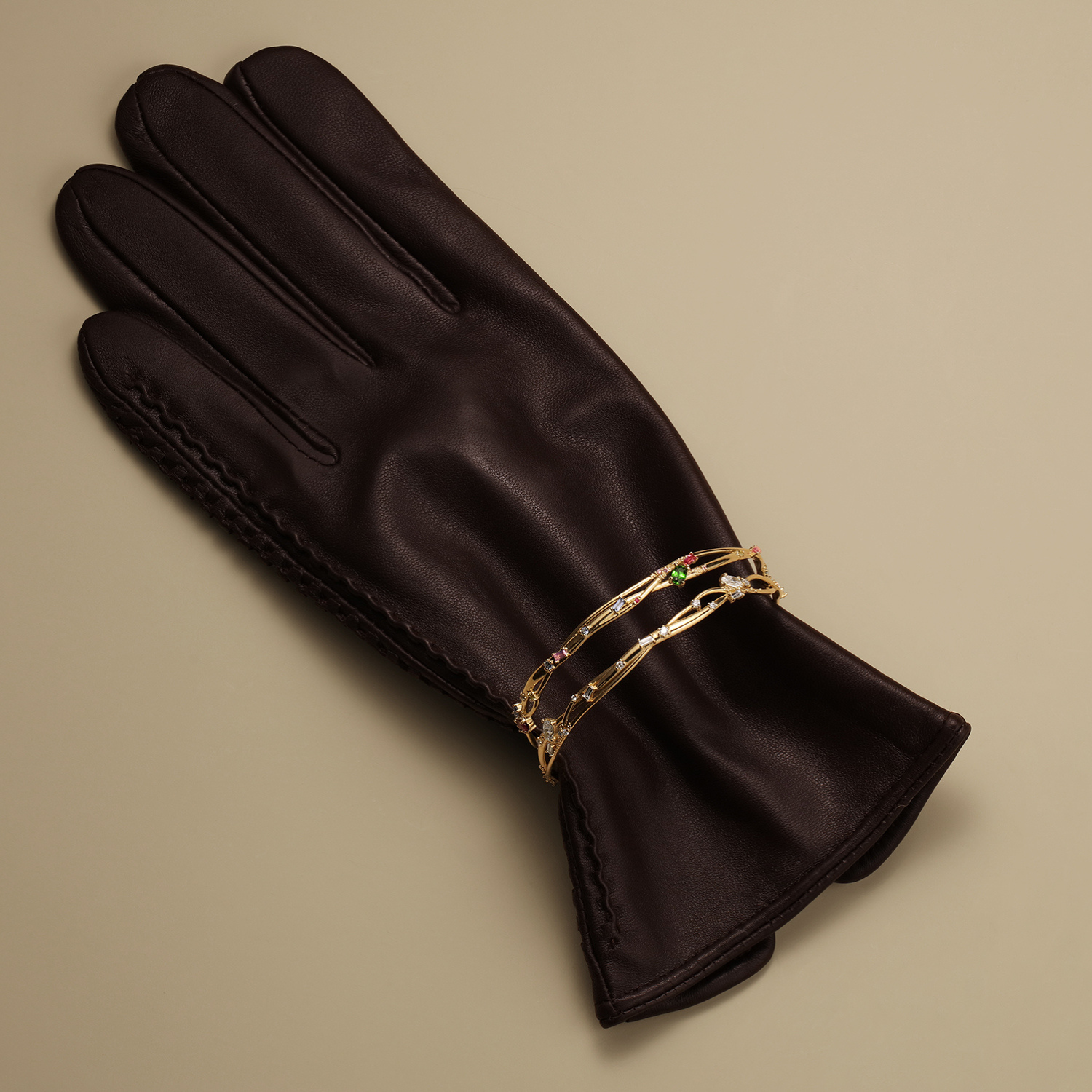 two organic interweaving bangles in 14k gold with colorful gemstones by jessica liu