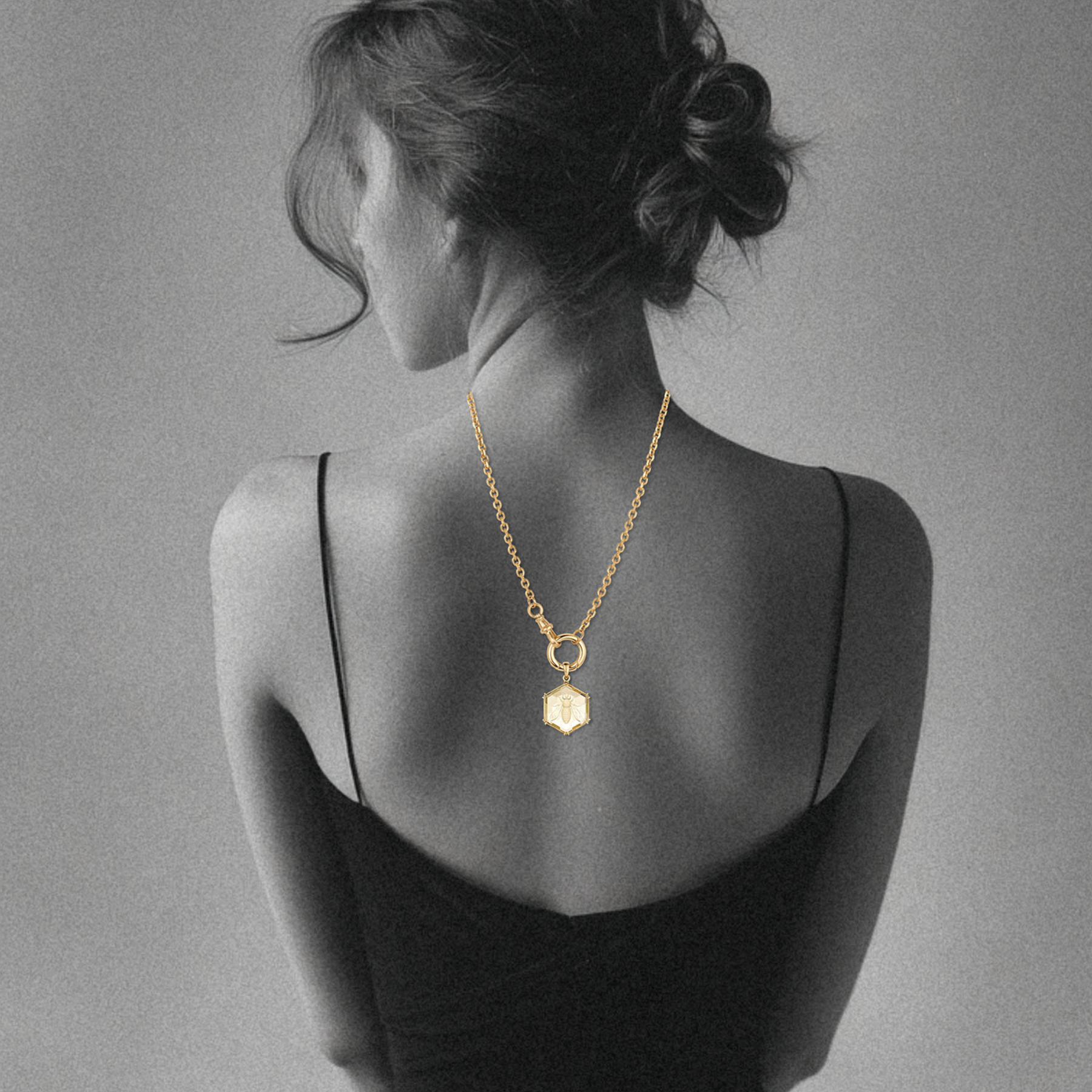 woman's back showing 14k gold cable chain with swivel clasp and enhancer bail with a hexagon carved citrine stone by jessica liu