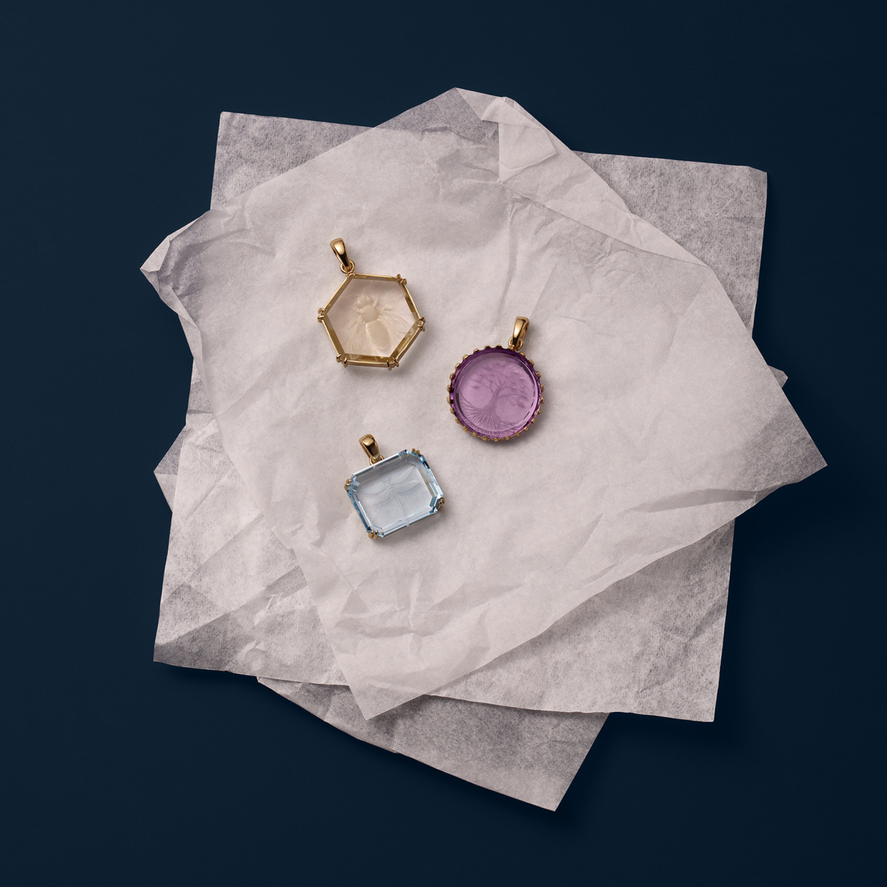 three colorful intaglio pendants