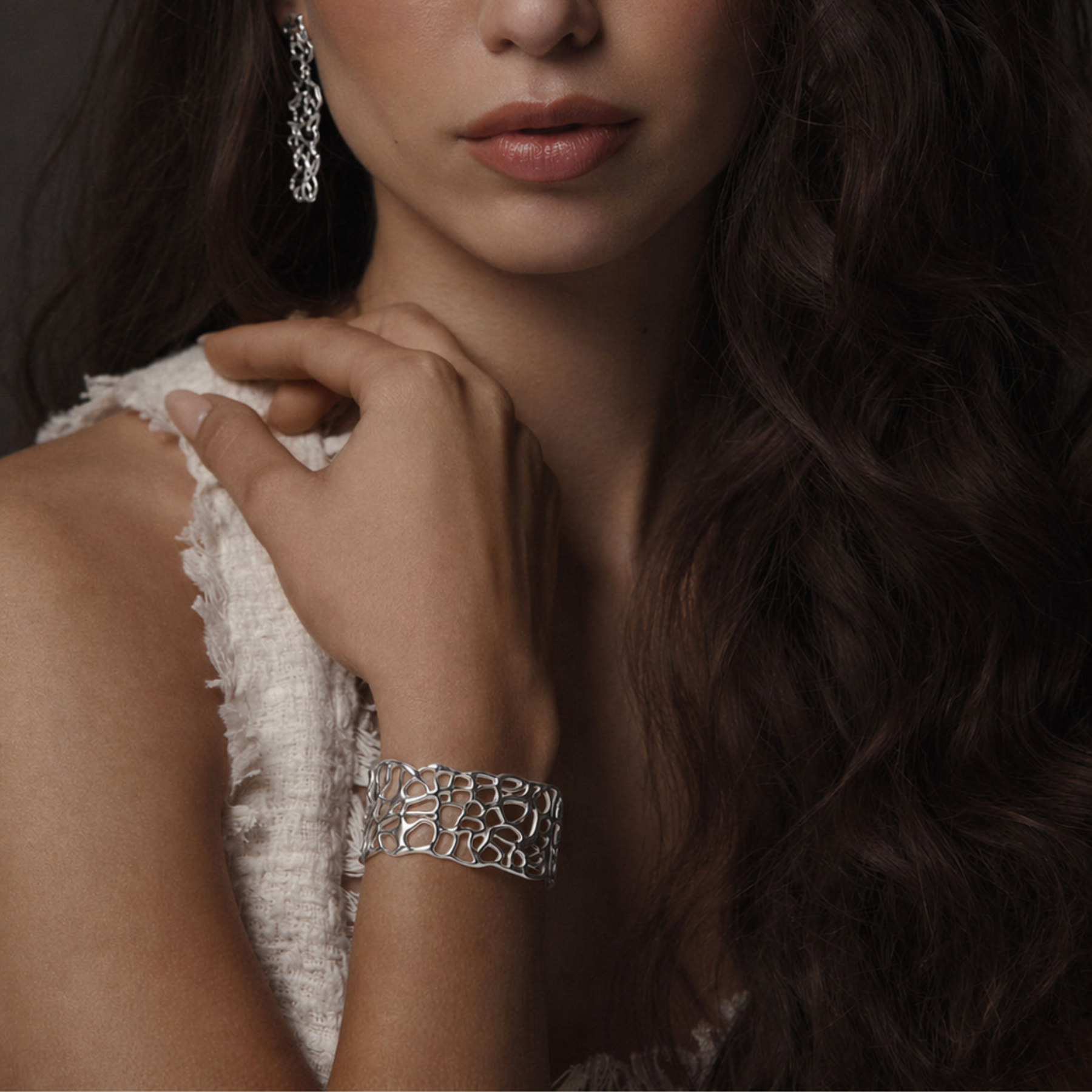 model's wrist showing organic and fluid coral cuff bracelet in silver by jessica liu