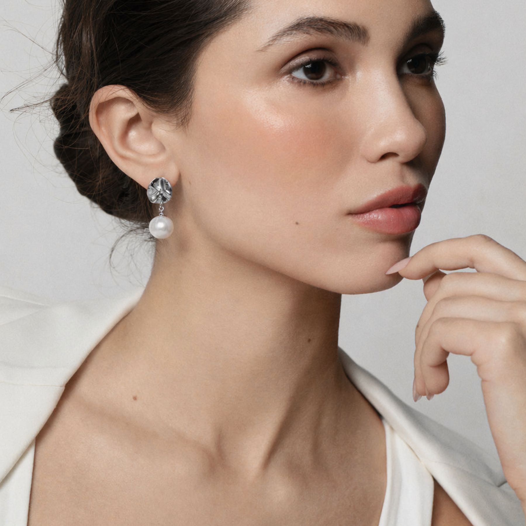 model wearing organic lily pad earrings in silver with a pearl drop by Jessica Liu