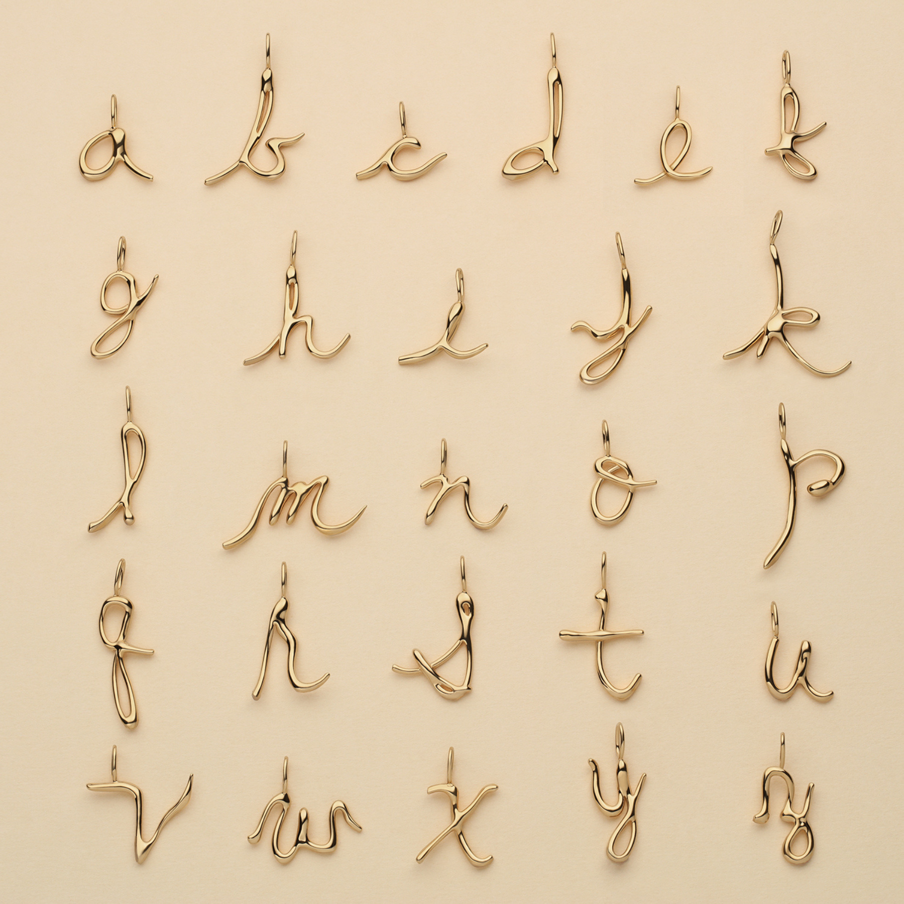 grid of 14k gold alphabet letter pendants a through z by jessica liu
