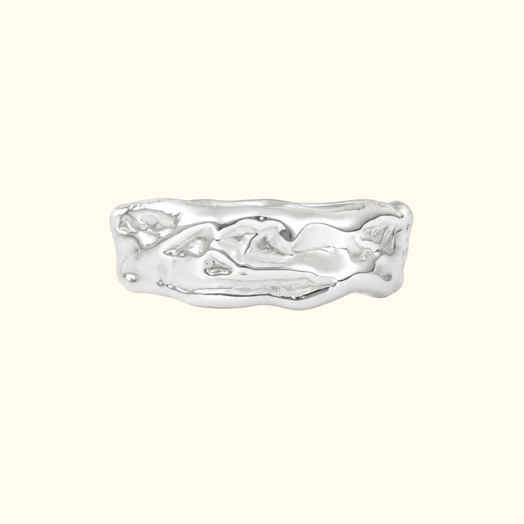 A textured sterling silver ring by Jessica Liu with an organic, wavy, fluid-like shape, shown on a solid cream background.