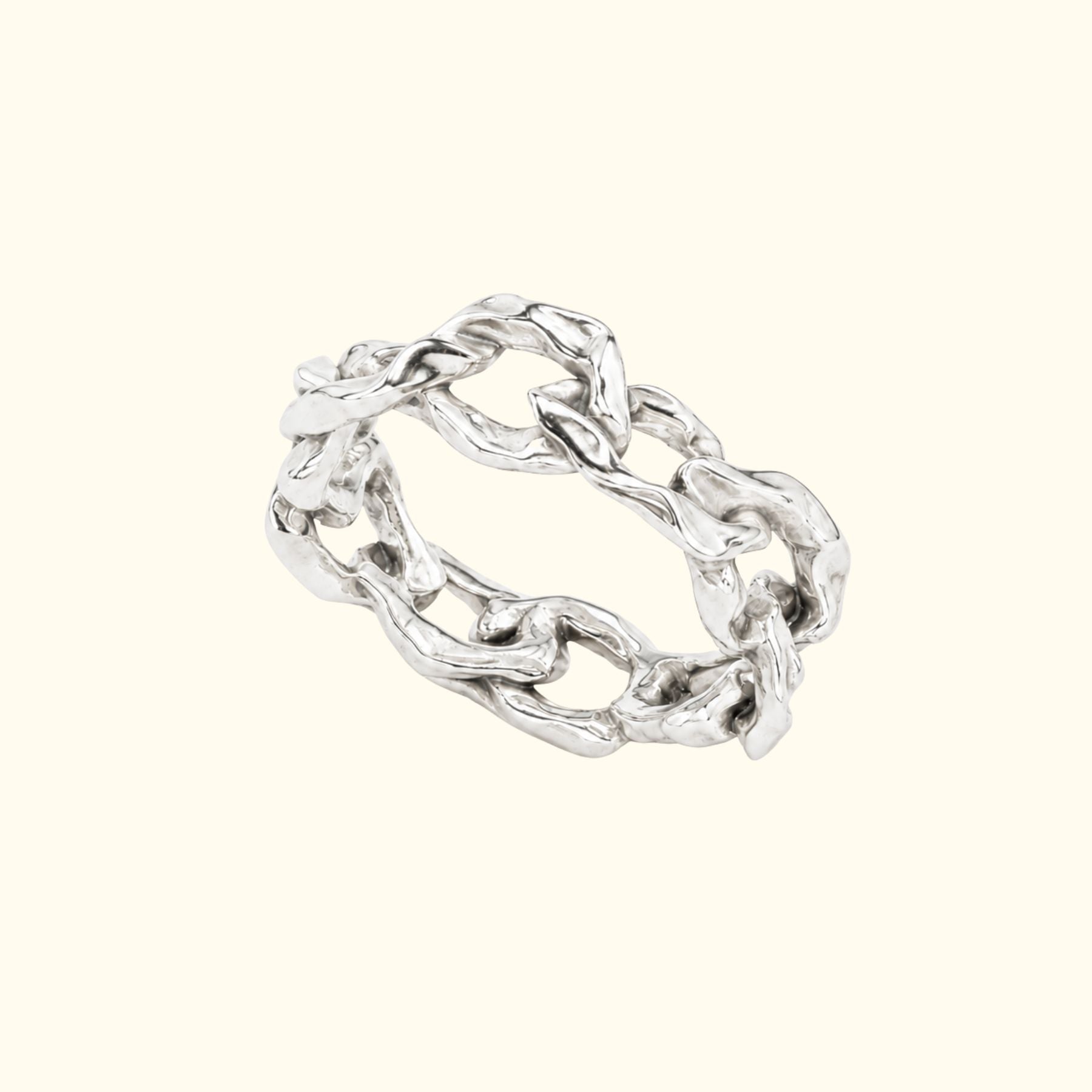 A chunky silver chain-link ring by Jessica Liu with a textured, polished finish, displayed on a solid cream-colored background.